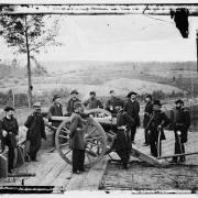 General Sherman, leaning on breach of gun, and staff at Federal Fort 7 outside Atlanta.