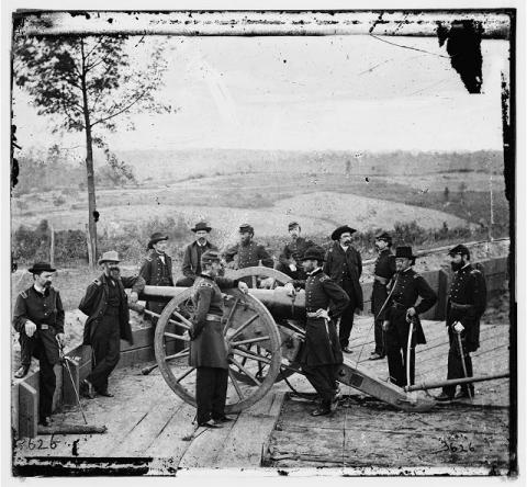 General Sherman, leaning on breach of gun, and staff at Federal Fort 7 outside Atlanta.
